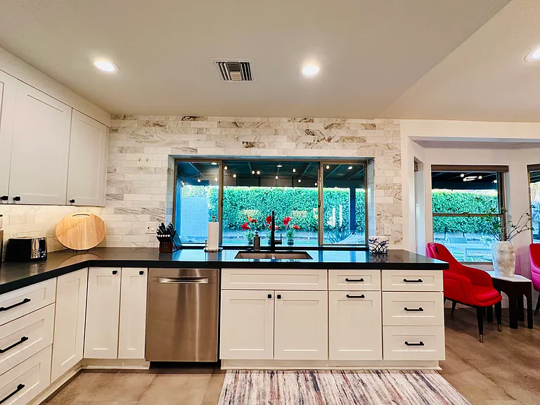 Chef's Kitchen: 
Fully equipped with everything you need to prepare a nice meal, featuring quartz countertops, a coffee maker, and a massive center island perfect for meal prep and casual entertaining.
