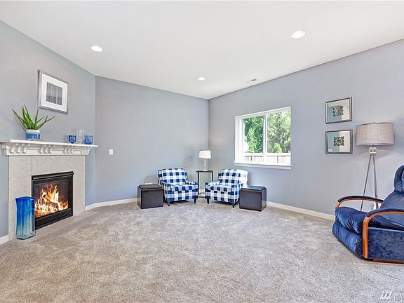 Family room features a beautiful gas fireplace with tile surround