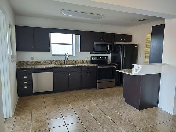 Kitchen granite countertops and lots of cabinets and storage