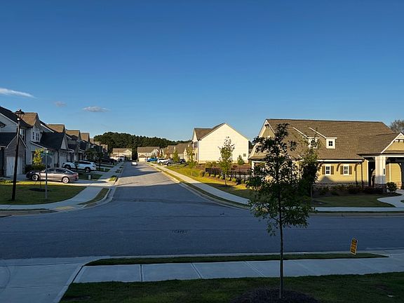 Road/street view from home, corner lot on right side is community area with Swimming Pool