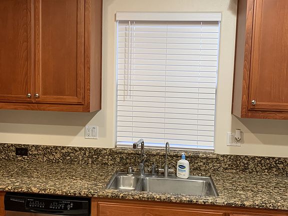 Kitchen side view showing dishwasher and sink. Sink equipped with in-sink drinking water hot and cold
