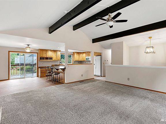 Upper level living area runs seamlessly into the dining and kitchen area.>