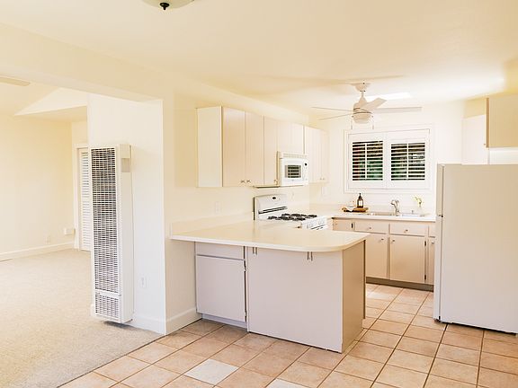 Light and bright kitchen with plenty of storage and a bar area for dining.