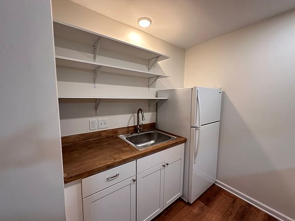 Galley kitchen with food-safe butcher block counters and plenty of storage space.