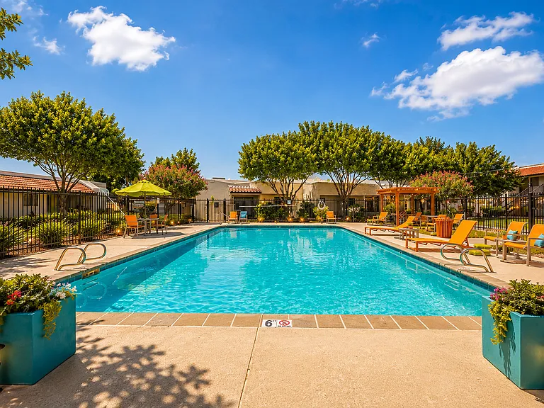 Sunny resort pool with vibrant decor