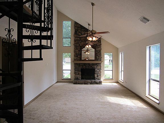 View of Living Room (24x13) from the Breakfast Area.  Spiral Staircase on the left
