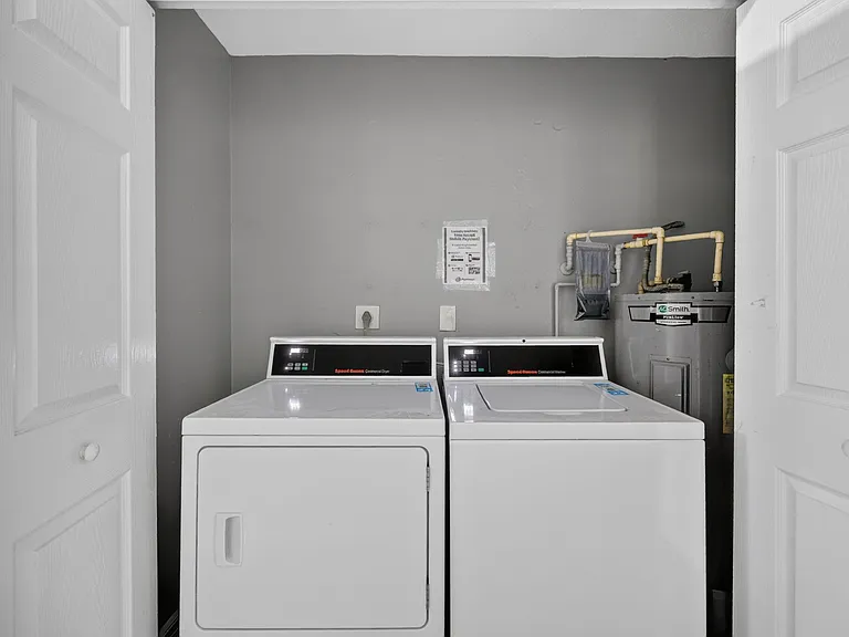 Dedicated laundry closet with full-size washer and dryer for convenient in-home laundry.