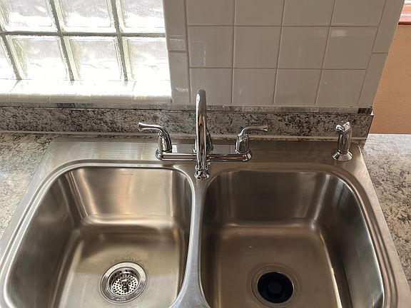 New kitchen sink (9 inches deep) with garbage disposal on right side.