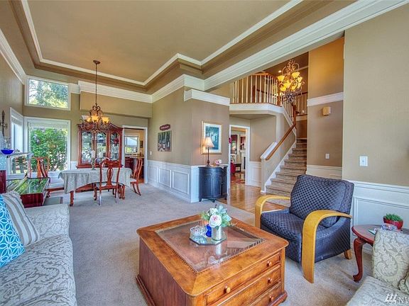 Spacious formal dining & living room complete with exquisite coffered ceilings and crown molding.