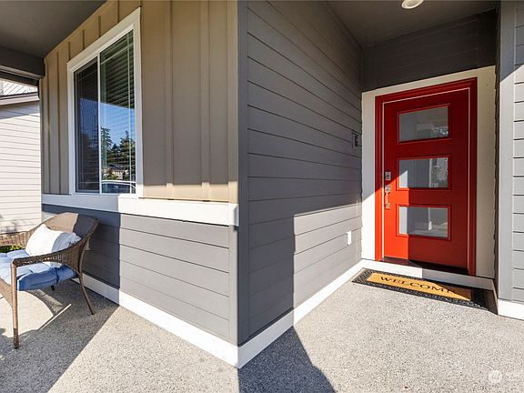 Covered front entrance with security doorbell and keyless entry.>