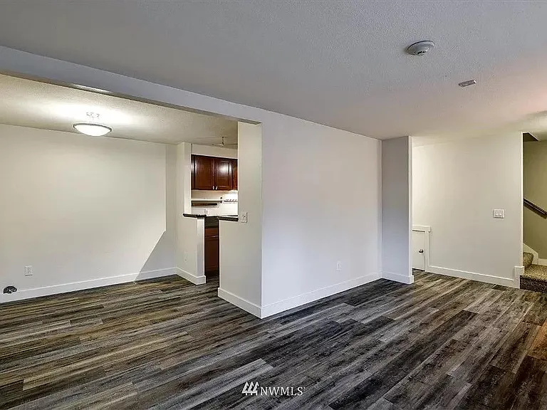 Spacious first floor with cozy dining area, spacious living room, and functional galley kitchen with plenty of storage.