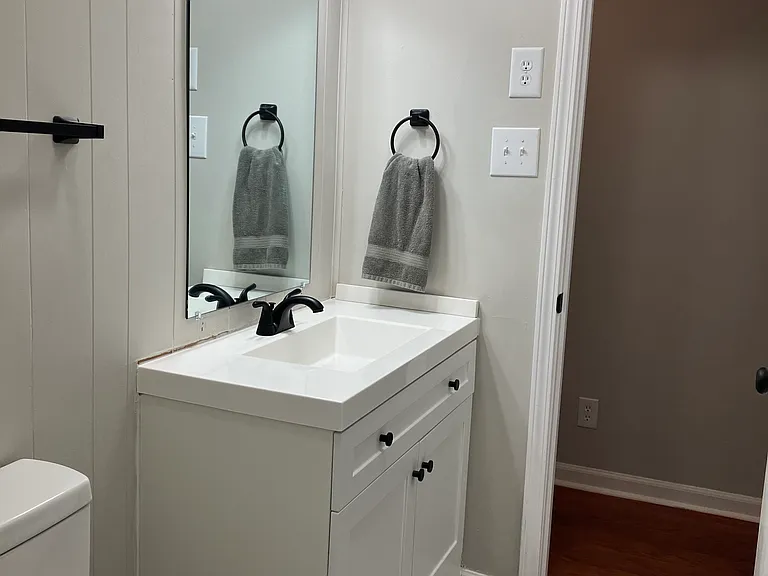 Upper level half bath with stackable washer and dryer