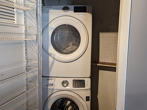 Stacked washer and dryer are included! Located conveniently off of kitchen.
