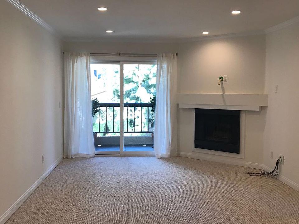 Family room with fireplace, leading to the balcony. 