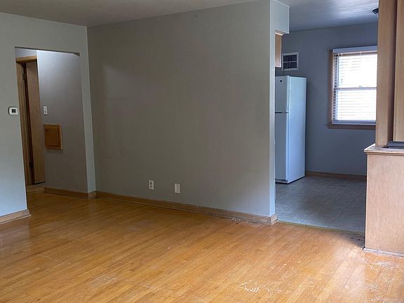 Living room, 13'x16', from front door view, hallway to left, kitchen/dining room on right
