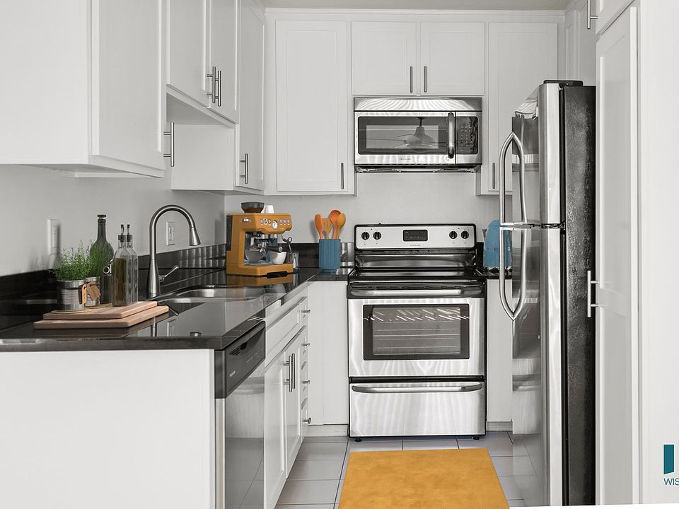 Kitchen with Stainless-Steel Dishwasher, Stove, Microwave Oven, and Refrigerator and Ample Cabinet Storage