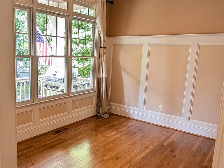 Flex space room on first floor overlooks front porch has several hardwired Cat5e connections making it a perfect office with lots of natural light. Has remote controlled fan with light dimming.