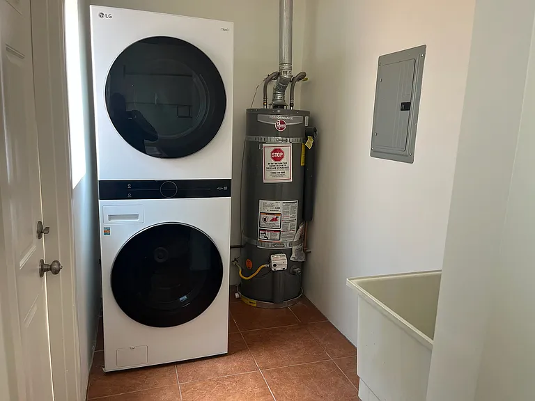 The in-unit laundry room with a side door that leads to the private back patio