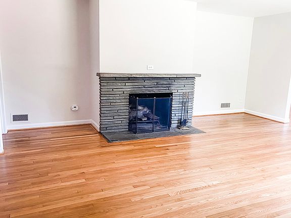 Large living room with fireplace and large forward facing window.
