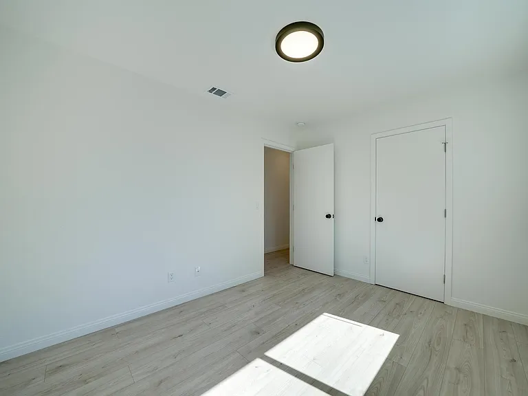 3rd bedroom. New paint, blinds, flooring, light fixtures. Walk-in closet door on the right.
