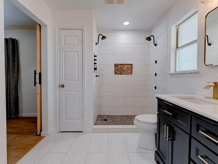 Main bath shower w/ dual shower heads and triple body sprays.