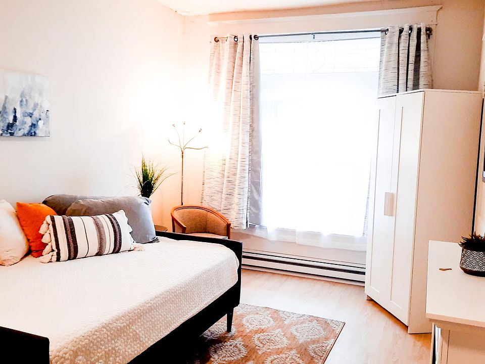 Bright Living area with Blackout Curtains, Daybed, Closet Fireplace, and Smart TV