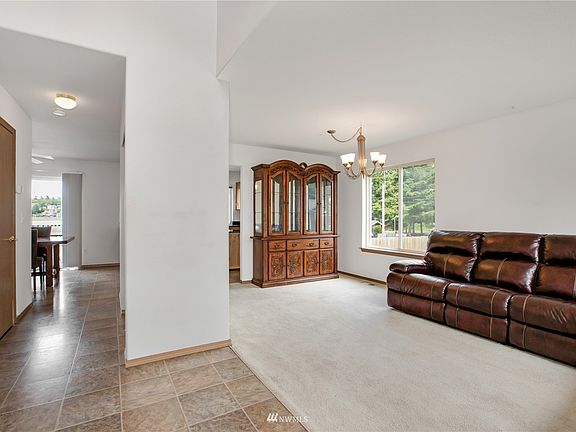 Walk into this open hallway with vaulted ceiling to formal living & dining area combo>