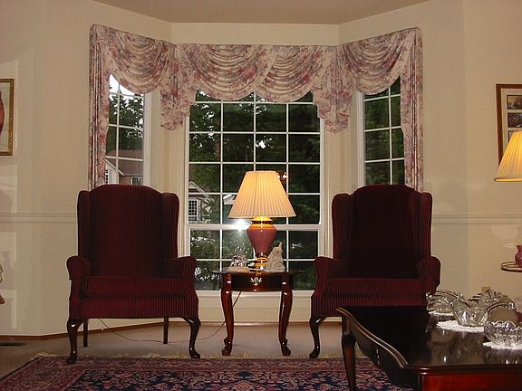 Cozy formal living room offers a bay window and alcove ceiling for intimate ev
