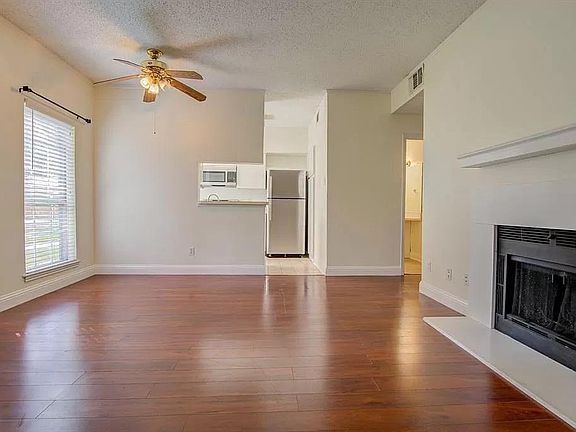 Another view of living room, looking at dining nook and kitchen area.