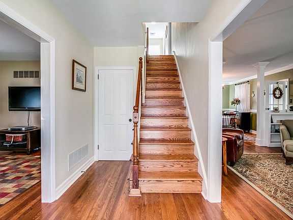 Inviting entrance hall with gleaming hardwood flrs