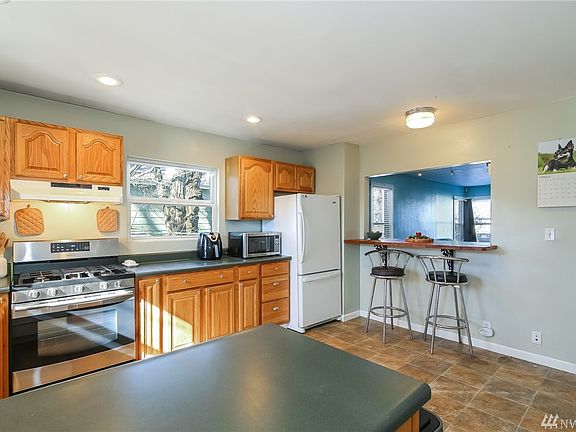 Another View of Kitchen - Cut-out Open to Living Room & Dining Space + Room for Dining Table.  Breakfast Bar & Access to Back Porch & Yard.