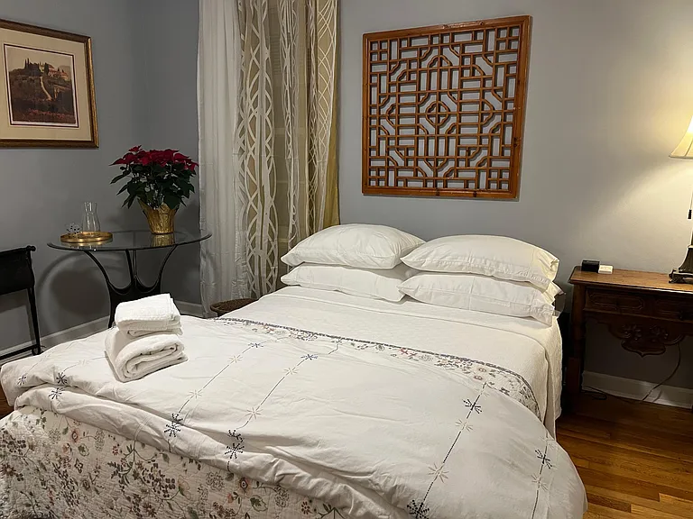 Second bedroom, bed, glass table and side cabinet