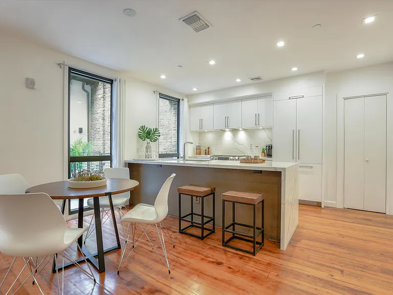 The dining area and kitchen are equipped with high-end, built-in Bosch appliances.