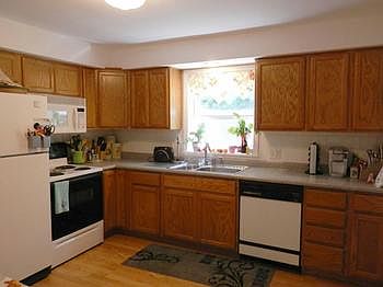 Newer cabinets & laminate floor in this applianced kitchen