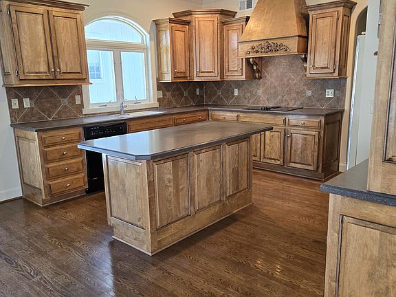 Kitchen with hardwoods, Corian counters, fresh paint.