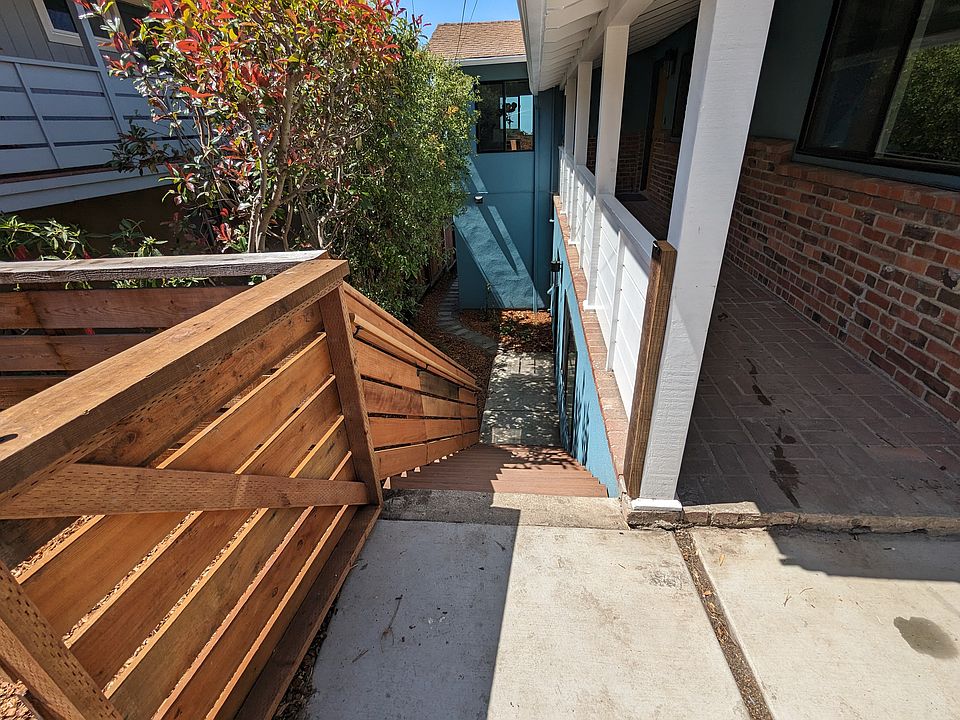 Gated front entrance with stairs down to unit
