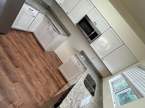 There is a stove. This is the last picture the contractor sent me of the kitchen, before he replaced the stove and took the plastic off the cabinets.