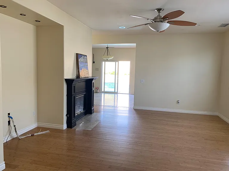 Living room with bamboo flooring and fireplace.