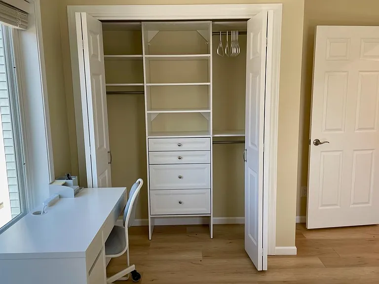 Bedroom 1 workstation and closet.