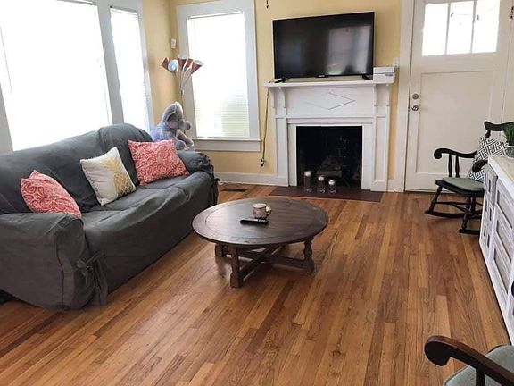 Den area with hardwood flooring throughout