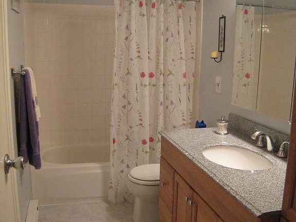 Bathroom with granite counter and tile shower/floor