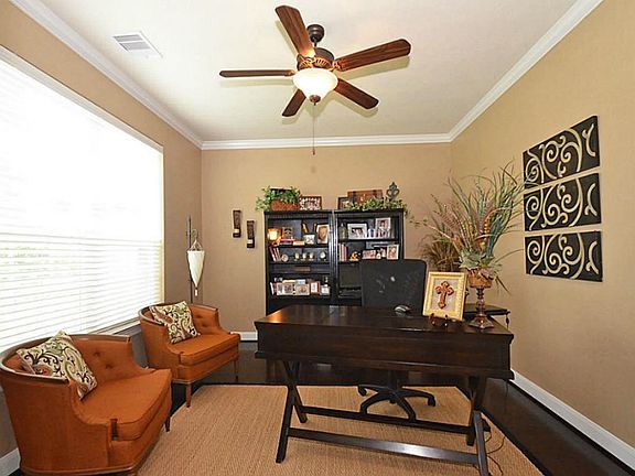 Study has wood floors, ceiling fan and 2" faux wood blinds.