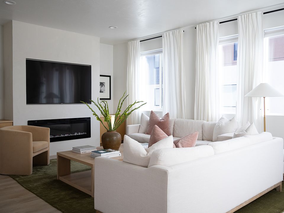 living room with electric fireplace and built in oak cabinets