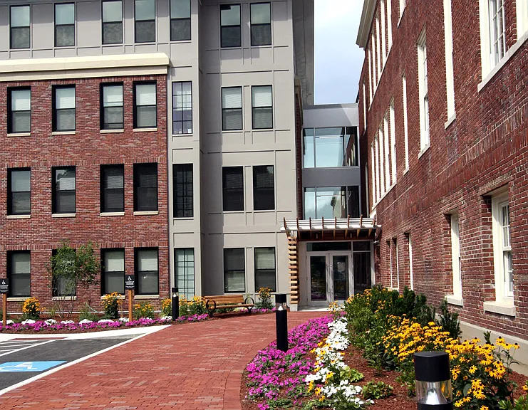Garden next to walkway leading to main entrance