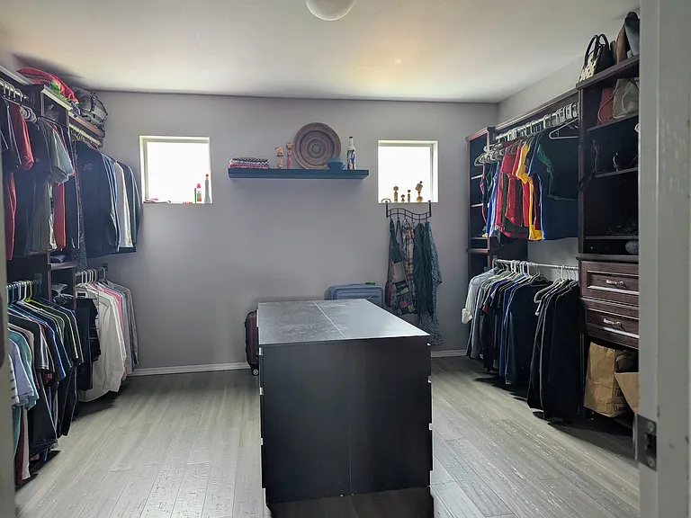 Massive 13' x 13' walk-in closet off Master Bedroom with built-in shelving. His and her's dressers can remain or be removed as desired.
