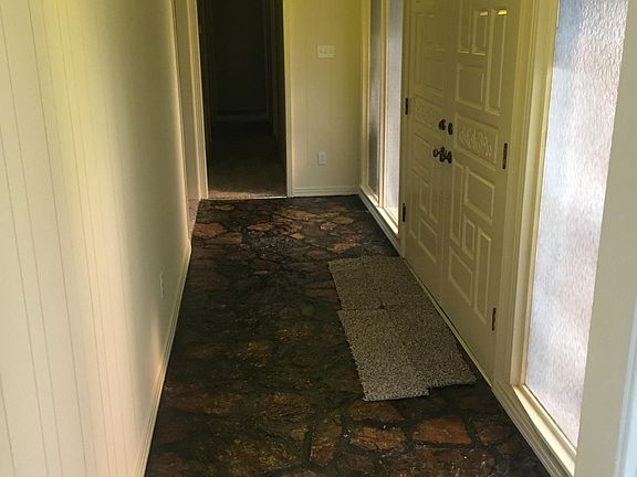 Native Stone entry w/ double front doors and 4 large daylight windows