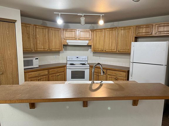 Kitchen with sitting bar.