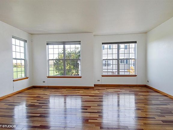 Living room w/ brazilian cherry wood floors, lots of dayligh