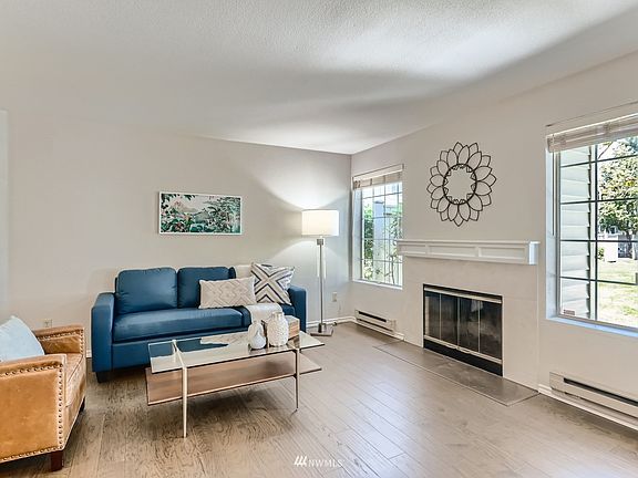 Beautiful laminate wood flooring and wood burning fireplace.