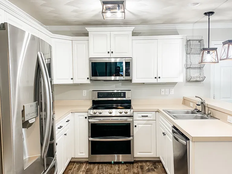 Kitchen with stainless steel appliances and double oven.